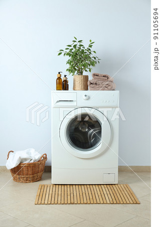 Concept of housework with washing machine against white wall Concept of housework with washing machine against white wall 91105694