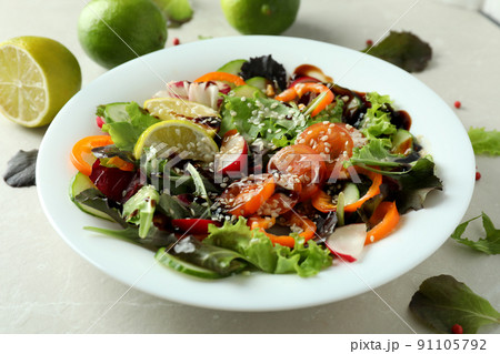 Concept of tasty food with vegetable salad with tahini sauce on light textured background 91105792