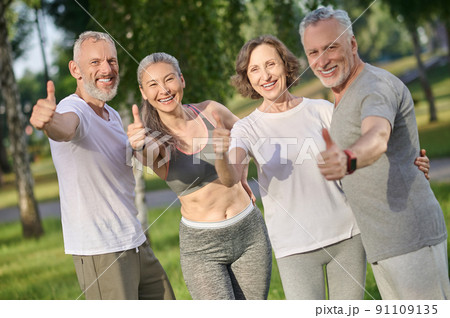 Group of people spending time together in the park and looking happy 91109135