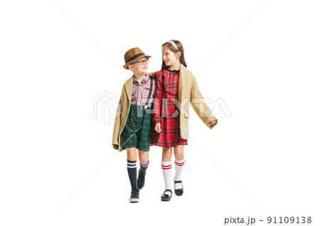 Portrait of little boy and girl, charming kids retro style outfit, fashion of 70s, 80s years isolated on white studio background with copy space for ad. Portrait of little boy and girl, charming kids retro style outfit, fashion of 70s, 80s years isolated on white studio background with copy space for ad. 91109138