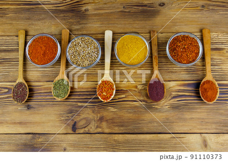 Set of different aromatic spices on wooden table. Top view Set of different aromatic spices on wooden table. Top view 91110373
