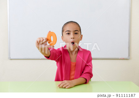 Little girl in office training correct pronunciation practicing different sounds Little girl in office training correct pronunciation practicing different sounds 91111187