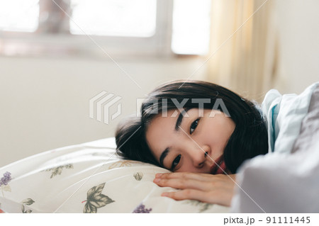 Eye contact with young adult asian woman sleep in bedroom on morning. Eye contact with young adult asian woman sleep in bedroom on morning. 91111445