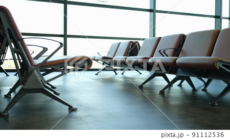 Empty brown leather chairs in airport lounge Empty brown leather chairs in airport lounge 91112536