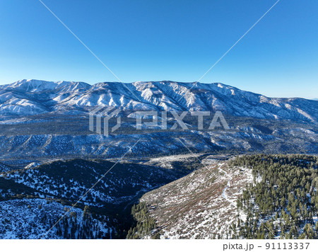 Aerial view over Big Bear Valey and Lake with now, South California, USA 91113337