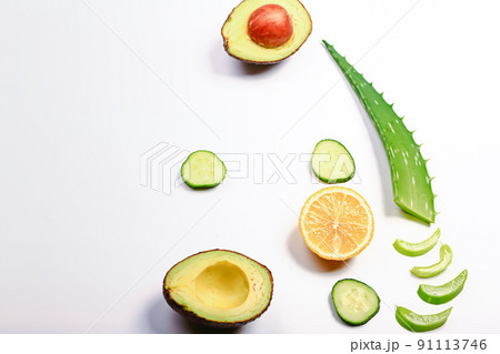 Ingredients mask of aloe on a light background. Aloe plant, avocado, cucumber, honey and lemon. Homemade natural cosmetics and treatments Ingredients mask of aloe on a light background. Aloe plant, avocado, cucumber, honey and lemon. Homemade natural cosmetics and treatments 91113746