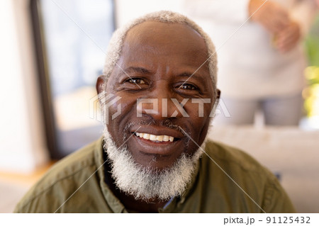 Close-up portrait of smiling bearded african american senior man in nursing home 91125432