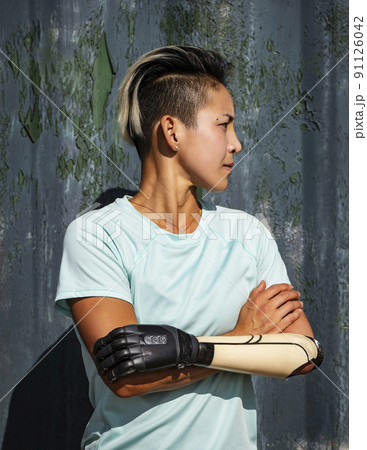 Portrait of athlete woman with prosthetic arm 91126042