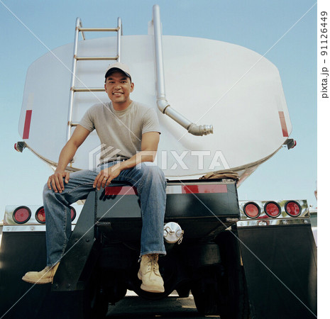 Truck driver sitting on his vehicle Truck driver sitting on his vehicle 91126449
