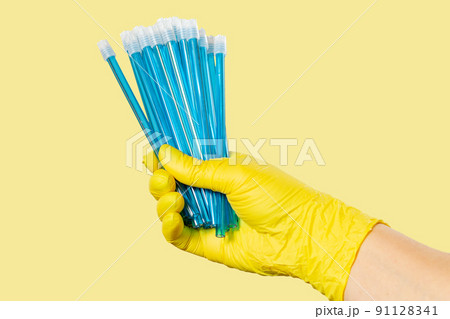 Dentist's hand in glove with saliva ejectors. 91128341