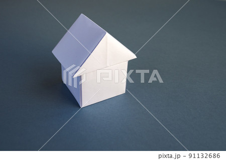 White paper house origami isolated on a grey background 91132686