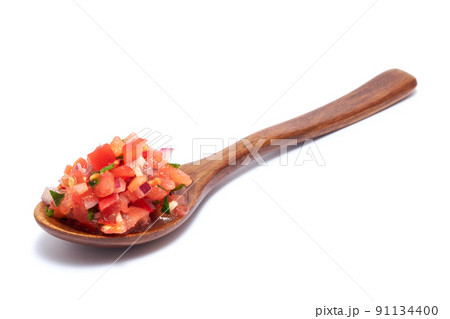 Spoon full of tomato salsa dip isolated on white background Spoon full of tomato salsa dip isolated on white background 91134400