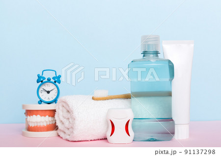 Mouthwash and other oral hygiene products on colored table top view with copy space. Flat lay. Dental hygiene. Oral care kit. Dentist concept Mouthwash and other oral hygiene products on colored table top view with copy space. Flat lay. Dental hygiene. Oral care kit. Dentist concept 91137298