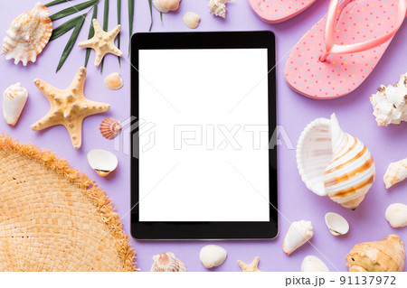 Flat lay composition with tablet and beach accessories on colored background. Tablet computer with blank screen mock up with copy space 91137972