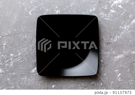 Top view of empty square plate on cement background. Empty space for your design Top view of empty square plate on cement background. Empty space for your design 91137973