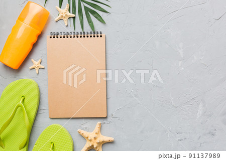 Blank writing book with summer beach accessories on background, copy space. Flat lay with copy space 91137989