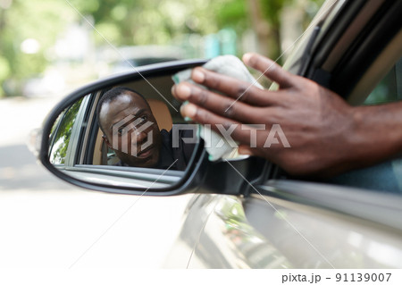 Man Wiping Back View Mirror 91139007