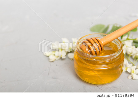 robinia honey bollte with acacia blossoms on colored table robinia honey bollte with acacia blossoms on colored table 91139294