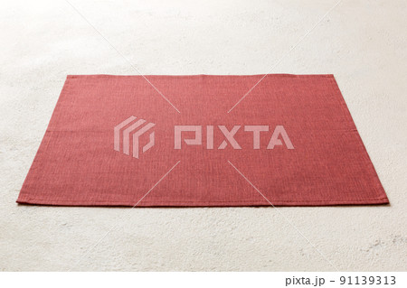 Perspective view of red tablecloth for food on cement background. Empty space for your design 91139313