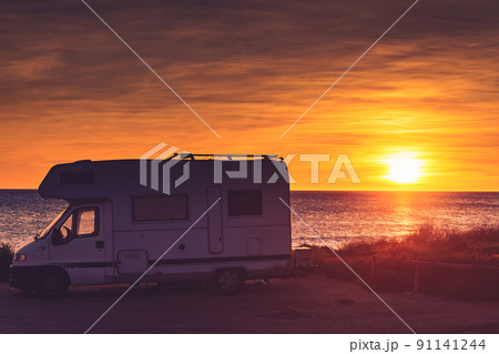 Camper car on beach at sunrise 91141244