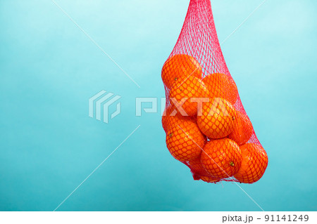 Fresh oranges fruits in mesh from supermarket Fresh oranges fruits in mesh from supermarket 91141249