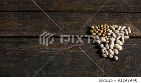 Legumes (beans). several types of dried beans. White and green beans on a wooden texture. Food. Close. White beans green beans. Brazilian diet snack. Concept 91143440