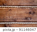 detail view of wooden wall decorated with jute rope 91146047