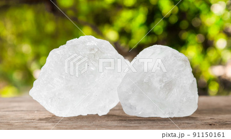 Crystal clear alum cubes or Potassium alum on wood plank. Chemical compound substance. Concept for beauty , spa and underarm treatment industrial. Crystal clear alum cubes or Potassium alum on wood plank. Chemical compound substance. Concept for beauty , spa and underarm treatment industrial. 91150161