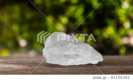 Crystal clear alum cubes or Potassium alum on wood plank. Chemical compound substance. Concept for beauty , spa and underarm treatment industrial. Crystal clear alum cubes or Potassium alum on wood plank. Chemical compound substance. Concept for beauty , spa and underarm treatment industrial. 91150162