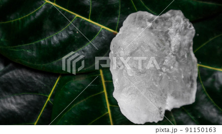 Crystal clear alum cubes or Potassium alum on green leaf. Chemical compound substance. Concept for beauty , spa and underarm treatment industrial. Crystal clear alum cubes or Potassium alum on green leaf. Chemical compound substance. Concept for beauty , spa and underarm treatment industrial. 91150163