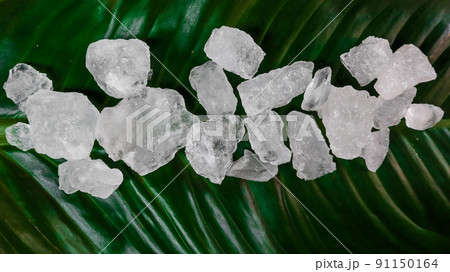 Crystal clear alum cubes or Potassium alum on green leaf. Chemical compound substance. Concept for beauty , spa and underarm treatment industrial. Crystal clear alum cubes or Potassium alum on green leaf. Chemical compound substance. Concept for beauty , spa and underarm treatment industrial. 91150164