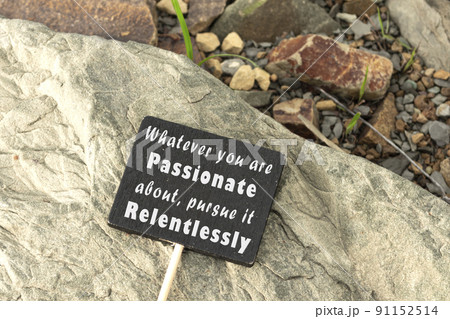 Motivational and inspirational quote on chalkboard on stone beach background. 91152514
