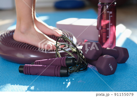 Person stands with feet on foot massage cushion closeup Person stands with feet on foot massage cushion closeup 91155079