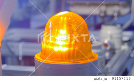 Close up of alarm lamp signal warning flashing light for industrial machinery 91157519