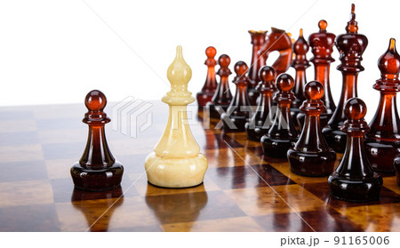 Natural amber different chess pieces figures standing on brown stone board. Close up game concept competition, Classic Gambit Tournament of confrontation. 91165006