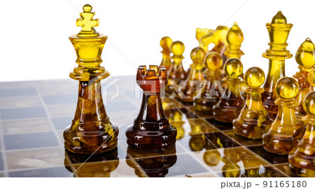 Natural amber different chess pieces figures standing on brown stone board. Close up game concept competition, Classic Gambit Tournament of confrontation. Natural amber different chess pieces figures standing on brown stone board. Close up game concept competition, Classic Gambit Tournament of confrontation. 91165180