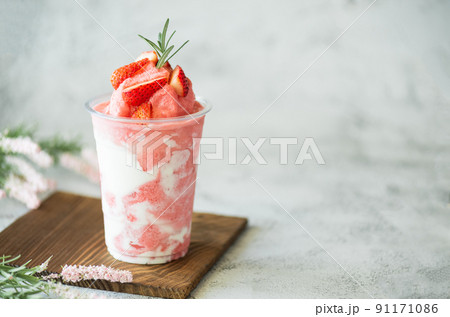 Closeup fresh strawberry milkshake, smoothie and fresh strawberries topping on stone table background. Healthy food and summer drink concept. 91171086