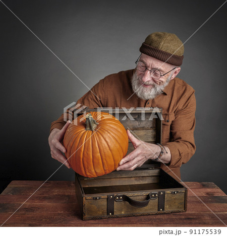 smiling senior man with pumpkin smiling senior man with pumpkin 91175539