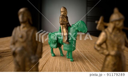 Statues of toy knights.Statues of toy knights. Knights with a sword. Variety of toy soldiers. The metal figures of the knights flickered against the light. Figurines of metal knights. 91179289