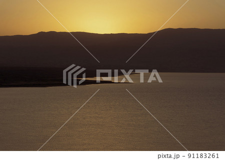 Orange sunrise reflecting off of the Dead Sea. Orange sunrise reflecting off of the Dead Sea. 91183261