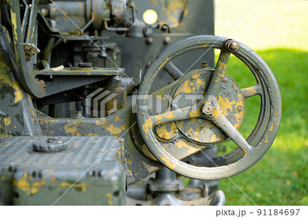 rusted guidance wheel on decommissioned artillery cannon 91184697