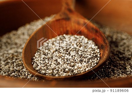Chia seeds in a bowl with wooden spoon Chia seeds in a bowl with wooden spoon 91189606