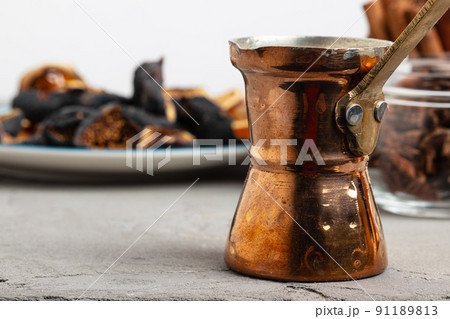 Copper turk with coffee and dried fruit pieces on table Copper turk with coffee and dried fruit pieces on table 91189813
