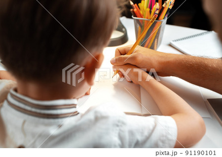 Little boy writing something in his notebook Little boy writing something in his notebook 91190101