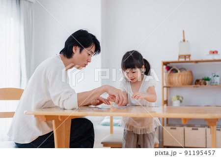 パパと一緒にパズルゲームをする小さな女の子 パパと一緒にパズルゲームをする小さな女の子 91195457