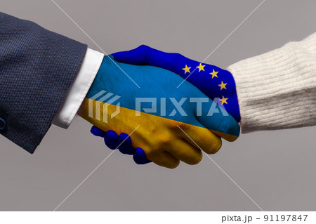 Ukraine and European Union flag, handshake closeup on grey background Ukraine and European Union flag, handshake closeup on grey background 91197847