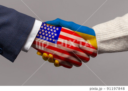 USA and Ukraine flag, handshake closeup on grey background USA and Ukraine flag, handshake closeup on grey background 91197848