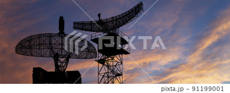 Air defense radars of military mobile anti aircraft systems, modern army industry on the background of the sunset orange sky, Russia 91199001