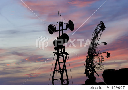 Air defense radars of military mobile anti aircraft systems, modern army industry on the background of the sunset orange sky, Russia Air defense radars of military mobile anti aircraft systems, modern army industry on the background of the sunset orange sky, Russia 91199007