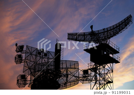 Air defense radars of military mobile anti aircraft systems, modern army industry on the background of the sunset orange sky, Russia 91199031